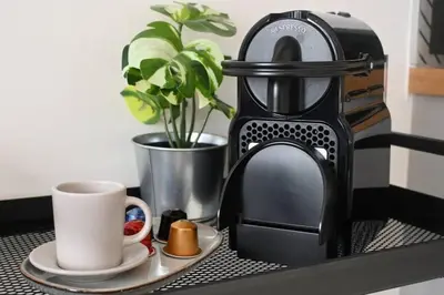 a coffee maker and a plate with a coffee cup at Dubai Hills Collective Tower 2 in Dubai