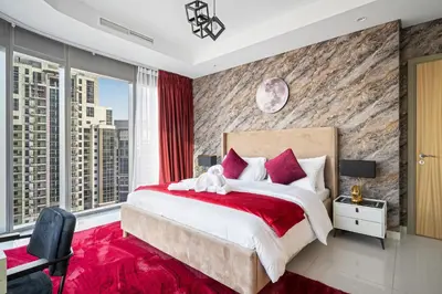 a bedroom with a large bed with red pillows at Super High Infinity Pool & Stunning Burj Khalifa View, 3-Bedroom Apartment at Paramount Hotel Midtown in Dubai