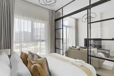 a bedroom with a large bed and a couch at Silkhaus Chic 1BDR in Exclusive Neighbourhood in Dubai