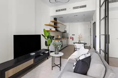 a living room with a couch and a flat screen tv at Silkhaus Chic 1BDR in Exclusive Neighbourhood in Dubai