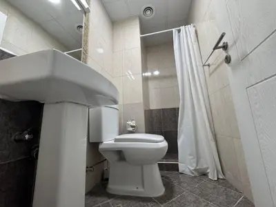 a bathroom with a white toilet and a shower at Luxury apartment 3 beds Marina view in Dubai