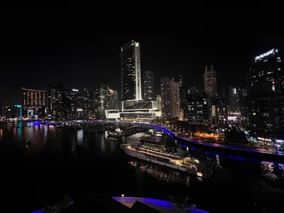 a city skyline at night with a bridge over the water at Luxury apartment 3 beds Marina view in Dubai