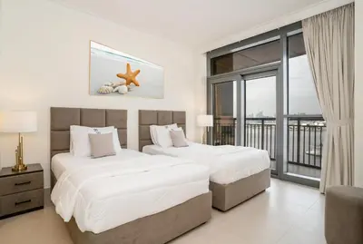 a hotel room with two beds and a balcony at Superior New Luxury Living 2BR Apt Dubai Creek Harbour in Dubai