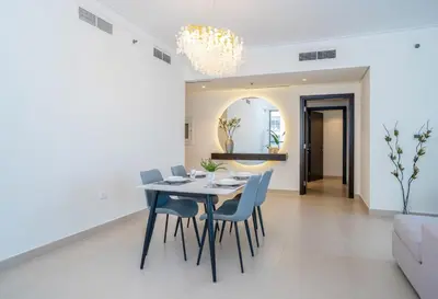 a dining room with a table and chairs at Superior New Luxury Living 2BR Apt Dubai Creek Harbour in Dubai