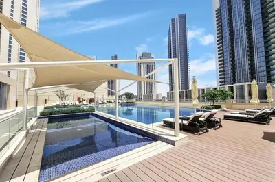 a swimming pool on a rooftop of a building at Homes Beyond l Spacious 2BR Creekside Lifestyle in Dubai