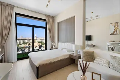 a hotel room with a bed and a couch at Modern Studio in residence with pool gym and paddl in Dubai