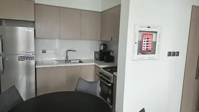 a small kitchen with a stove and a sink at MH- Act Tower - Downtown 1BHK-REF4606 in Dubai