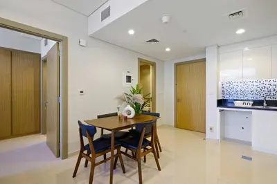a kitchen and dining room with a table and chairs at High-Floor 2BR in Aykon City Spacious, Good View in Dubai