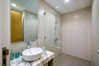 a bathroom with a sink and a shower at High-Floor 2BR in Aykon City Spacious, Good View in Dubai