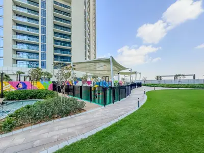 a playground in a park with a building at High-Floor 2BR in Aykon City Spacious, Good View in Dubai