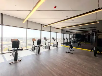 a gym with treadmills and exercise equipment in a building at High-Floor 2BR in Aykon City Spacious, Good View in Dubai