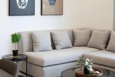a living room with a couch and two tables at SmartStay at Paramount Tower - Sea and Downtown Views - Infinity Pool - Modern Luxury Residences in Dubai