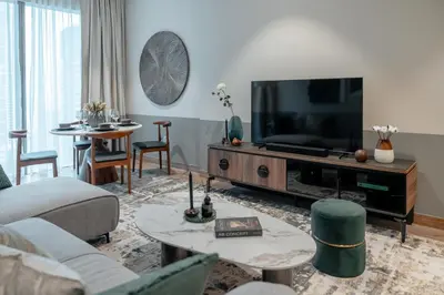 a living room with a couch and a tv at Clever Guest 018 JL Marina gate in Dubai