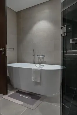 a white bath tub in a bathroom with a shower at Clever Guest 018 JL Marina gate in Dubai