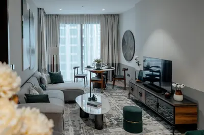 a living room with a couch and a tv at Clever Guest 018 JL Marina gate in Dubai