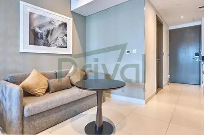a living room with a couch and a table at Prival - Prive in Dubai
