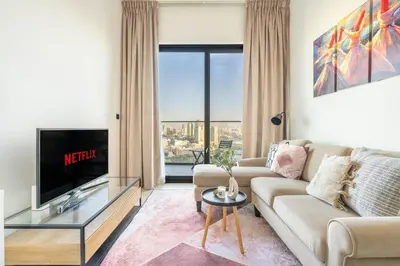 a living room with a couch and a tv at GuestReady - Marvellous home at Binghatti Heights in Dubai