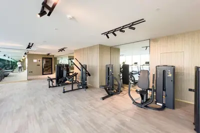a gym with treadmills and cardio equipment in a building at GuestReady - Marvellous home at Binghatti Heights in Dubai