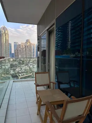 a balcony with chairs and a table and a view of the city at Apartment Dubai Marina, Damac Heights 804 in Dubai