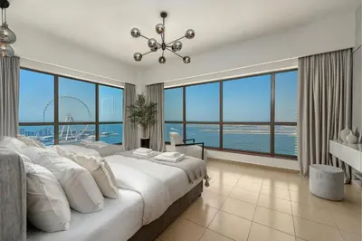 a bedroom with a large bed and large windows at Luxury Dubai Eye View Living - Beach access I Marina Walk in Dubai
