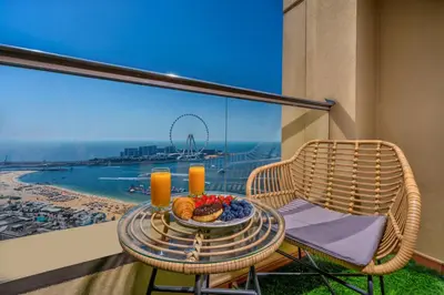 a table with a plate of food on a balcony with a view at Luxury Dubai Eye View Living - Beach access I Marina Walk in Dubai