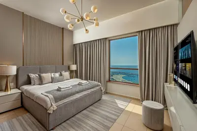 a bedroom with a large bed and a large window at Luxury Dubai Eye View Living - Beach access I Marina Walk in Dubai