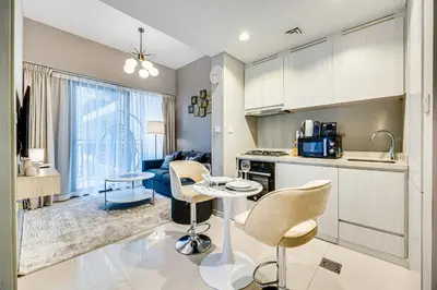 a kitchen with a table and chairs in a room at Brand new cozy 1 bedroom in Business Bay in Dubai