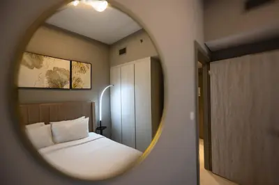 a bedroom with a bed and a mirror at Brand new cozy 1 bedroom in Business Bay in Dubai