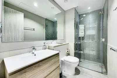 a bathroom with a sink and a toilet and a shower at Brand new cozy 1 bedroom in Business Bay in Dubai