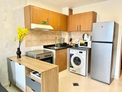 a kitchen with a refrigerator and a washer and dryer at Cosmos Living Stunning Apt in Lago Vista IMPZ in Dubai