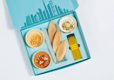 a picture of a lunch box with food and drinks at Cosmos Living Stunning Apt in Lago Vista IMPZ in Dubai