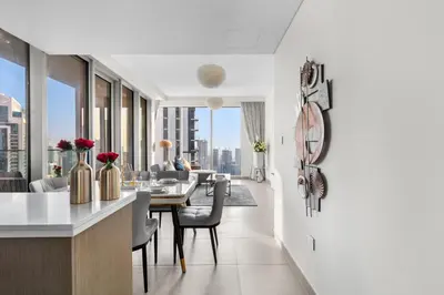 a kitchen and dining room with a view of a building at Luxury 4-Bed Escape in Downtown Dubai That Sleeps 9 in Dubai