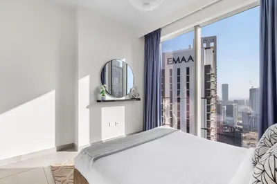 a bedroom with a bed and a large window at Luxury 4-Bed Escape in Downtown Dubai That Sleeps 9 in Dubai