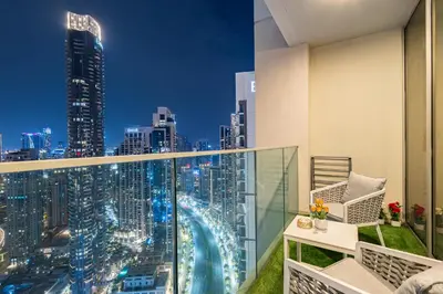 a balcony with a view of a city at night at Luxury 4-Bed Escape in Downtown Dubai That Sleeps 9 in Dubai
