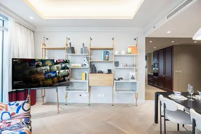 a living room with a dining table and a kitchen at The Address Fountain Views - Residence 2 Bedroom with Burj Khalifa view and access to Dubai mall in Dubai