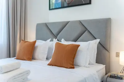 a bedroom with a large bed with white pillows at DIFC 1BR at SkyGardens Tower in Dubai