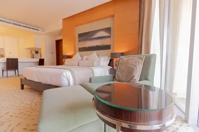 a hotel room with a bed and a table at Four Apple EMAAR Fashion Avenue Deluxe Studio in Dubai