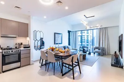 a kitchen and dining room with a table and chairs at FIRST CLASS 2BR In the HEART of Downtown Dubai in Dubai