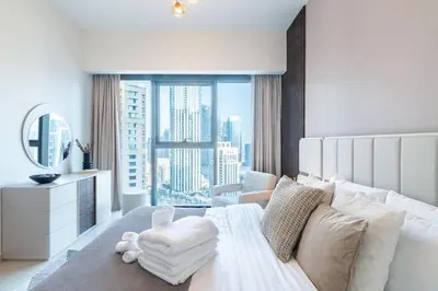 a bedroom with a white bed and a large window at FIRST CLASS 2BR In the HEART of Downtown Dubai in Dubai