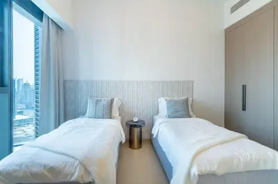 two beds sitting next to each other in a bedroom at FIRST CLASS 2BR In the HEART of Downtown Dubai in Dubai