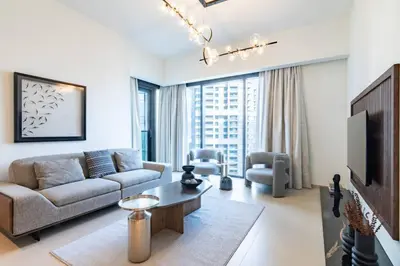 a living room with a couch and a tv at FIRST CLASS 2BR In the HEART of Downtown Dubai in Dubai