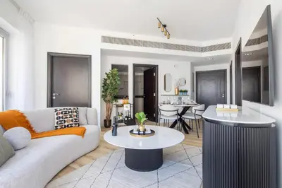 a living room with a couch and a table at Frank Porter - La Riviera Tower in Dubai