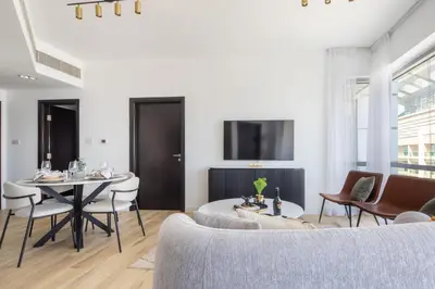 a living room with a table and chairs at Frank Porter - La Riviera Tower in Dubai
