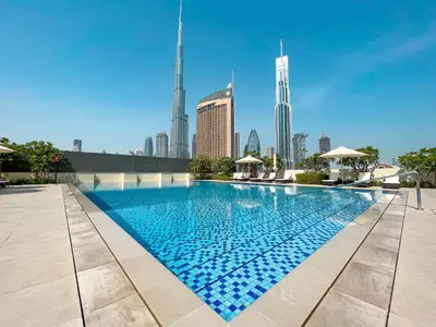 a swimming pool with a city skyline in the background at Trophy Live in the Sky Luxury Moon Collection Suites with DIFC Views 45Th Floor in Dubai