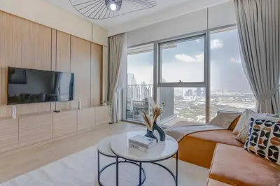 a living room with a couch and a tv at Trophy Live in the Sky Luxury Moon Collection Suites with DIFC Views 45Th Floor in Dubai