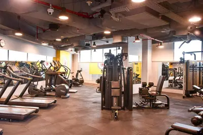 a gym with a bunch of tread machines in it at Heart of DIFC: SKY Gardens Modern Chic Studio in Dubai