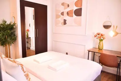 a living room with a white couch and a table at Heart of DIFC: SKY Gardens Modern Chic Studio in Dubai