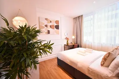 a bedroom with a bed and a potted plant at Heart of DIFC: SKY Gardens Modern Chic Studio in Dubai