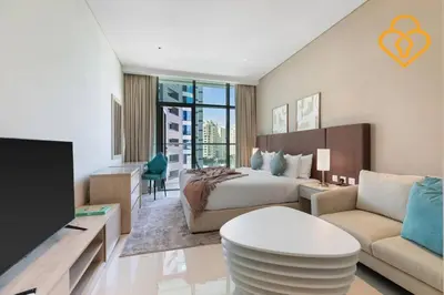 a bedroom with a bed and a living room at Keysplease Studio W/Beach Access near Mall, Palm Jumeirah in Dubai