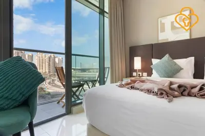 a bedroom with a large bed and a large window at Keysplease Studio W/Beach Access near Mall, Palm Jumeirah in Dubai